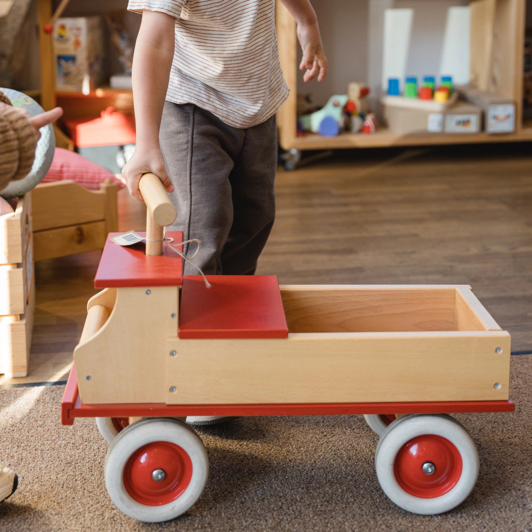 Rutschauto: LKW aus massivem Buchenholz, von einem Kind geschoben. Robuste Gummibereifung, verstellbare Sitz- und Ladefläche, hergestellt in einem deutschen Familienbetrieb. Nachhaltiges, ästhetisches Design von KLICKKLACK.