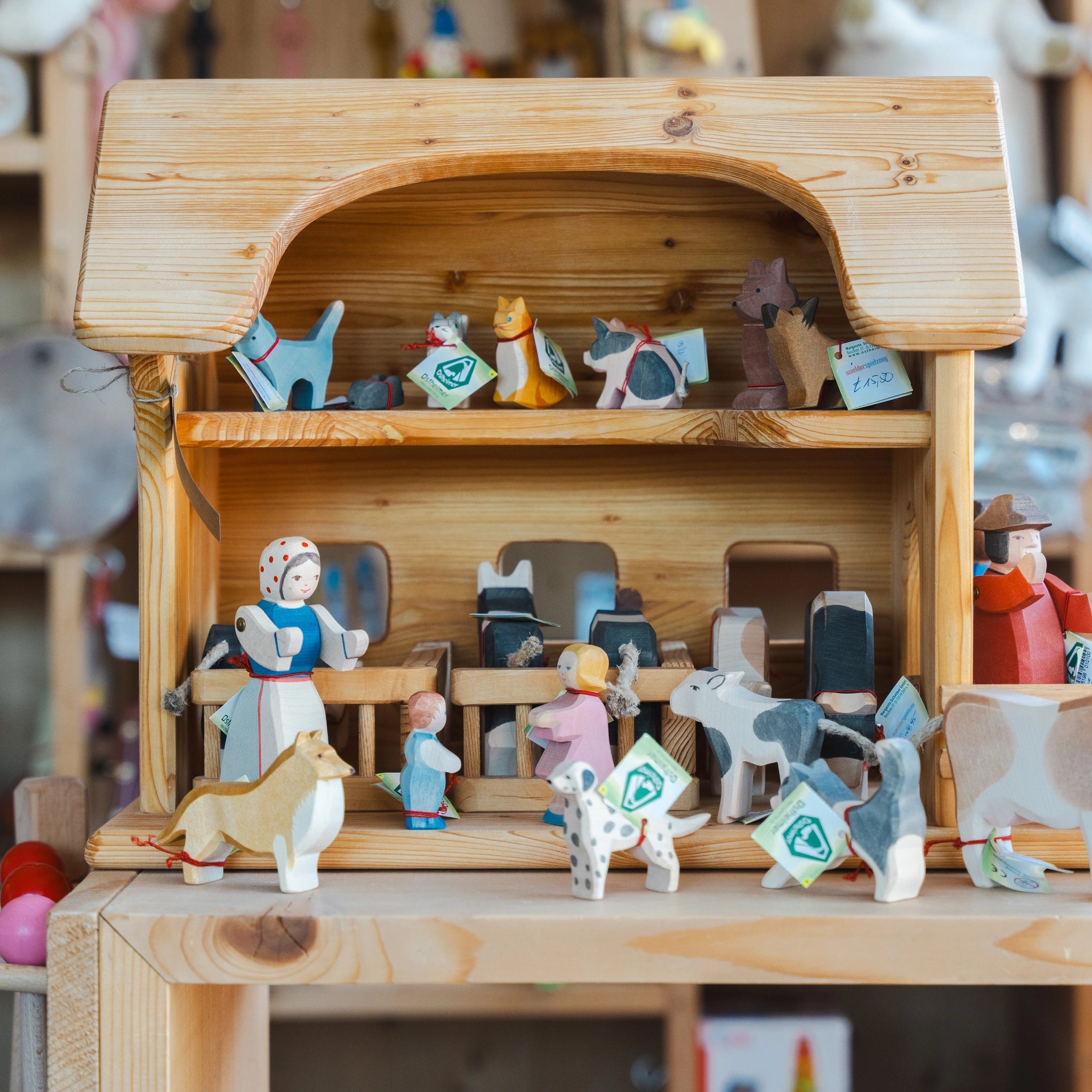 Holztier: Kuh braun stehend, aus massivem Ahornholz, liebevoll handbemalt, präsentiert in einem Puppenhaus-Display mit anderen Holzfiguren, ideal für kreatives Rollenspiel. Hergestellt in Deutschland.