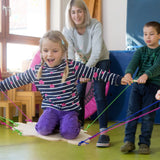 Kinder spielen begeistert mit dem Teamspiel: Strippensurfer, das Balance und Körperkoordination fördert und in geschützten Werkstätten in Deutschland hergestellt wird. Ideal für Gruppenaktivitäten von 4 bis 99 Jahren.