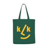 Stofftasche Tannengrün aus 100% recycelter Baumwolle mit fröhlichem KLICKKLACK-Design: typografisches Smiley-Gesicht in Gelb, lange Schulterriemen, praktische Innentasche, Balgfalte für Extra-Volumen.