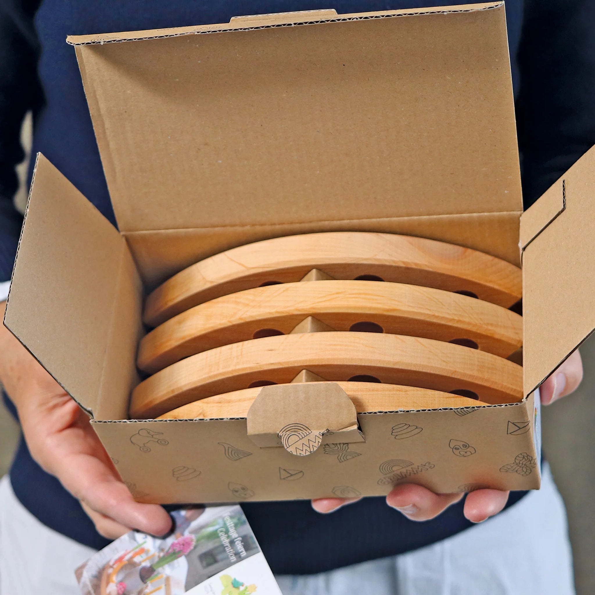 Freies Spiel: Großer Festtagsring natur, aus geöltem Erlenholz, zeigt vier identische Halbmond-Holzstücke mit je drei Löchern. Ideal für festliche Dekorationen, hergestellt in einer kleinen Manufaktur in Deutschland.