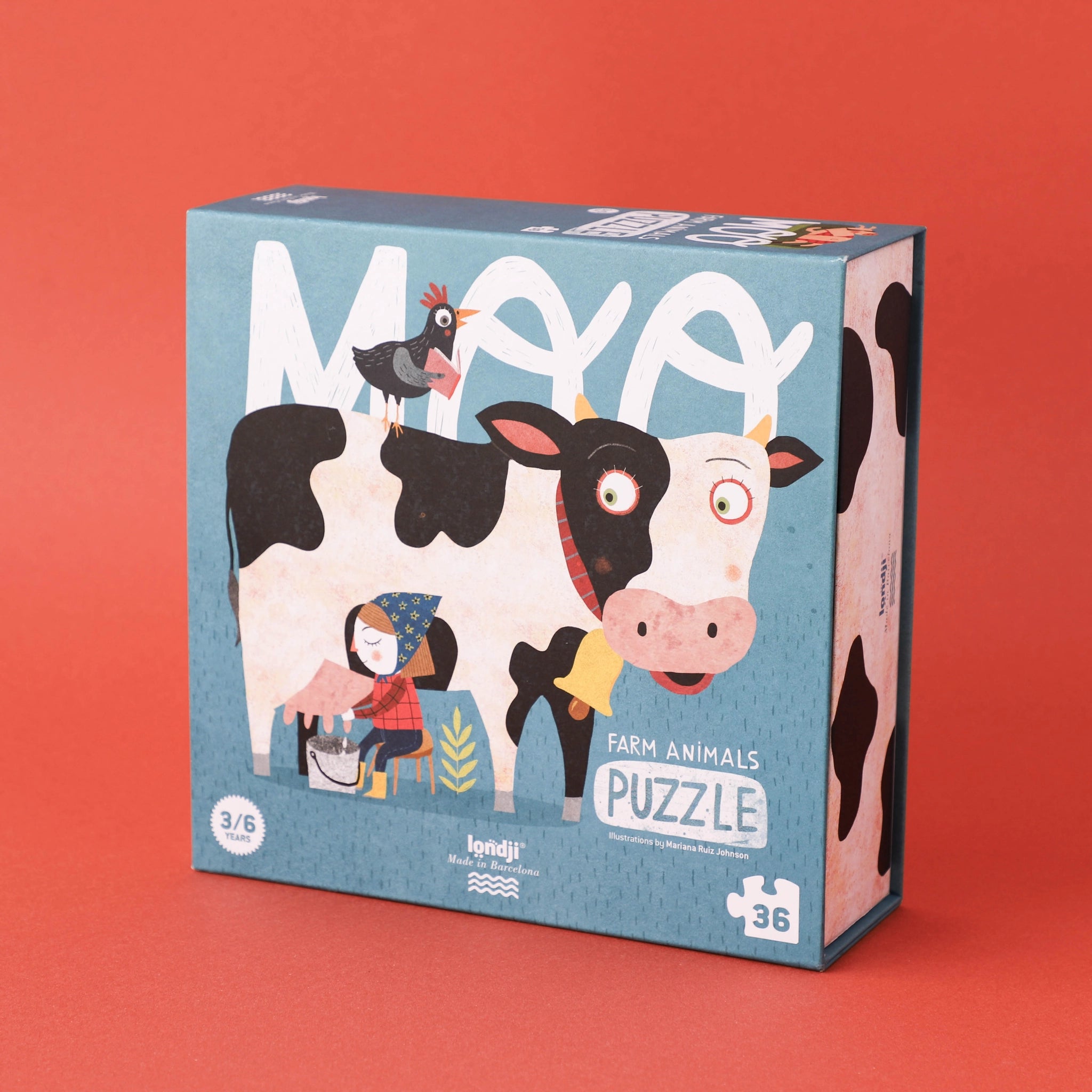 Puzzle: Moo - Eine Box mit einem Bauernhof-Puzzle, zeigt Comic-Kuh und Huhn. 36 große, leicht greifbare Teile, ideal für Kinder ab 3 Jahren. Hergestellt aus FSC-Papier und recyceltem Karton.