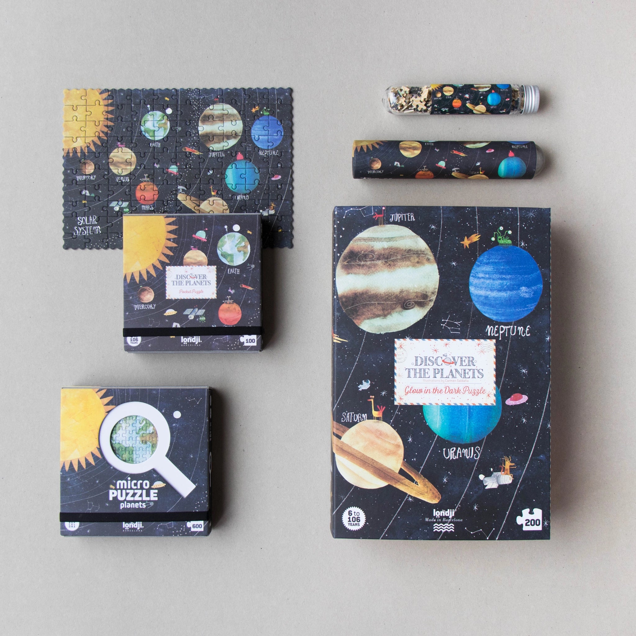 Puzzle: Discover the planets zeigt 200 Teile mit Planeten und Sonnenmotiv. Das Puzzle leuchtet im Dunkeln und wird aus FSC-Papier und recyceltem Karton für Weltraumfans gefertigt.