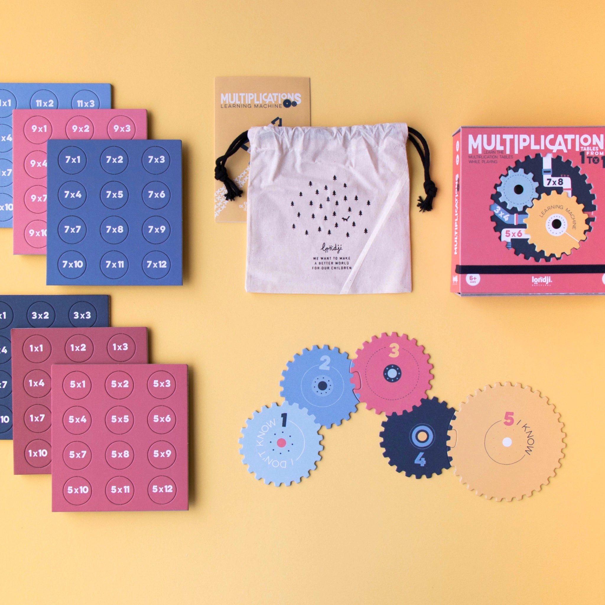 Lernspiel: Multiplications – Eine interaktive Sammlung von Mathematikspielen, hergestellt aus FSC-Papier und recyceltem Karton, mit Zahnrädern und Puzzleteilen, um das Einmaleins spielerisch zu lernen. Ab 6 Jahren geeignet.