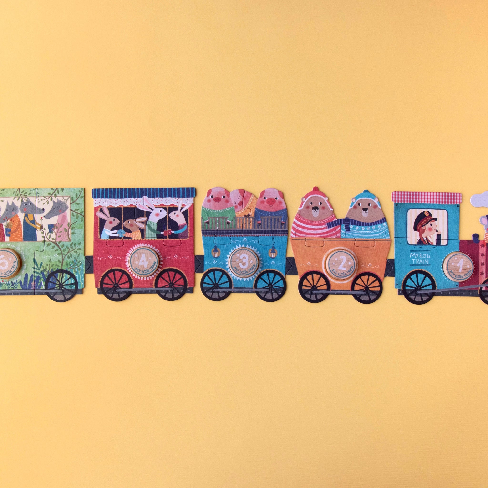 Puzzle: Mein kleiner Zug mit 10 dreiteiligen Waggons, verziert mit Cartoon-Tieren, fördert spielerisch das Zahlenlernen von 1 bis 10. Hergestellt aus FSC-Papier und recyceltem Karton für Kinder ab 2 Jahren.