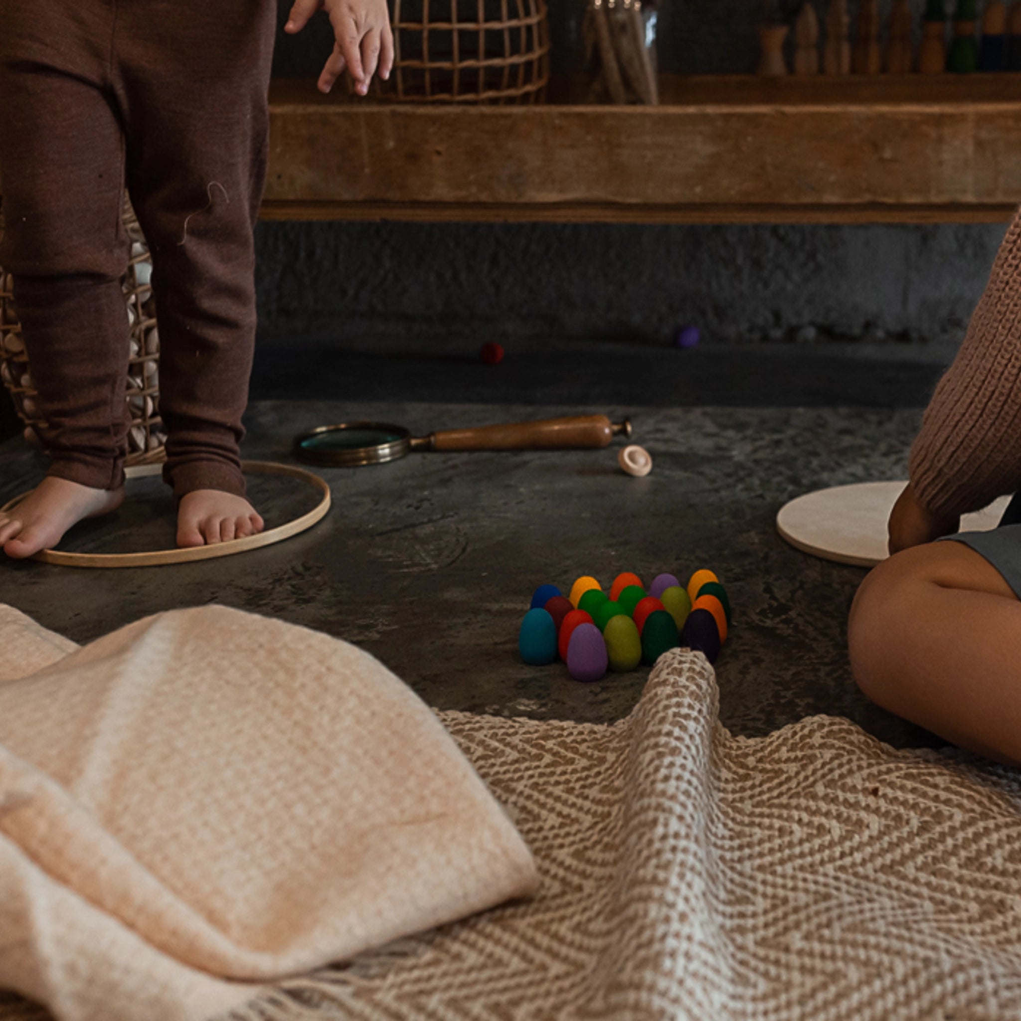 Freies Spiel: Mandala Rainbow Eggs, ein handgefertigtes Set aus 36 nachhaltig produzierten Holz-Eiern, ideal für kreative Kinderspiele und zum Gestalten von Mandalas, auf einem Tisch arrangiert.