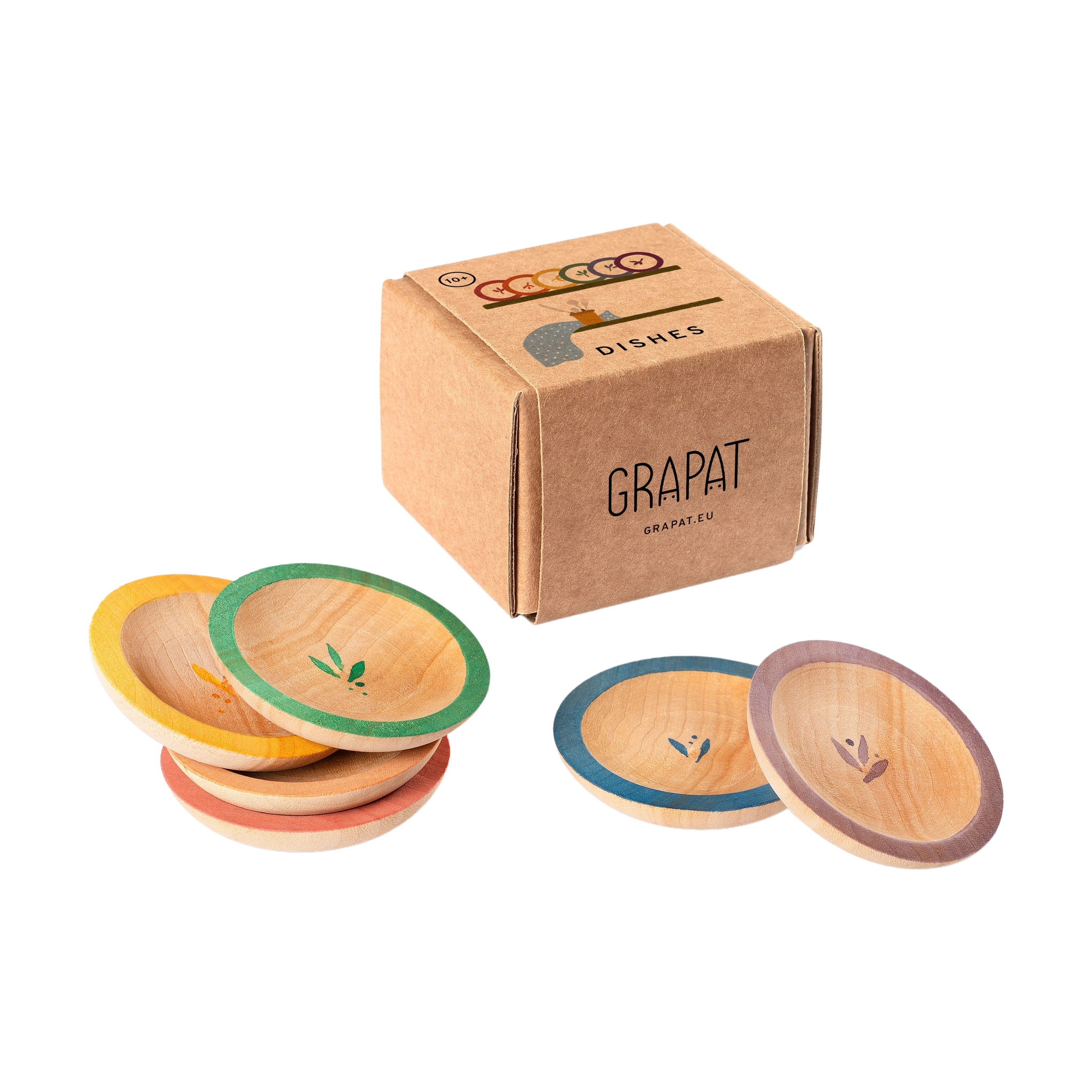 Freies Spiel: Dishes von Grapat, ein Set aus kleinen, runden Holzplatten mit farbigen Rändern und einem zarten Blattmotiv in der Mitte, präsentiert in einer schlichten Pappschachtel.